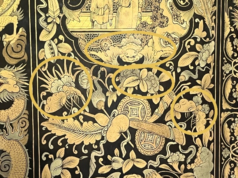 Detail photo of the screen highlighting the bats and butterflies. Two butterflies, a bat, and a flower are circled.
