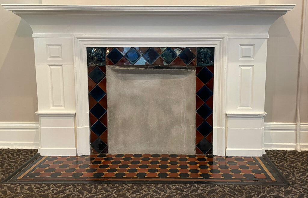 A modern photo of the fireplace in Merion's common room.